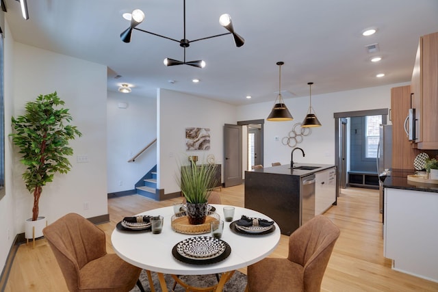 dining space featuring visible vents, light wood-style flooring, recessed lighting, stairway, and baseboards