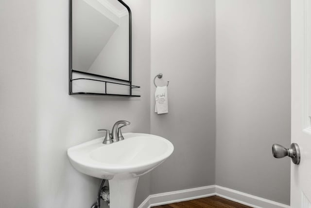 bathroom with baseboards and wood finished floors