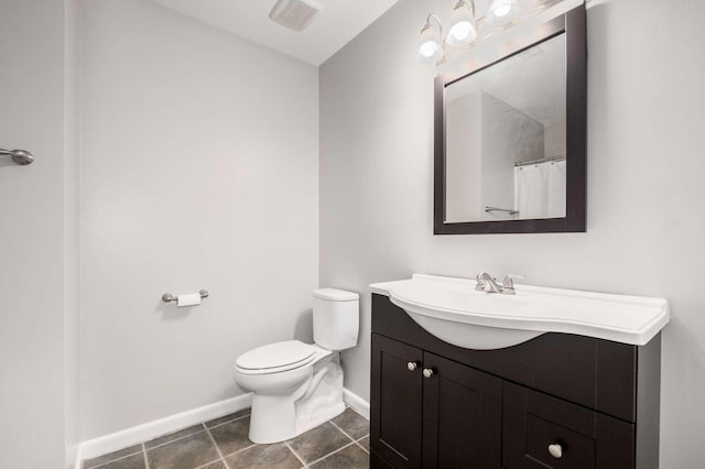 bathroom with visible vents, toilet, vanity, and baseboards