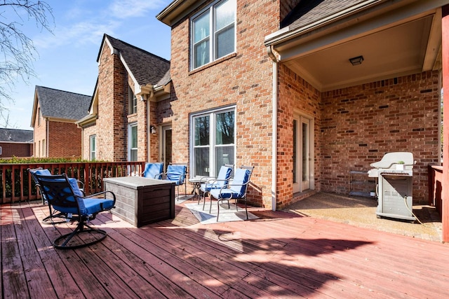 wooden deck featuring a grill and outdoor lounge area