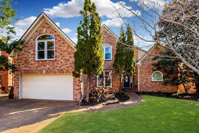 traditional home with driveway, brick siding, an attached garage, and a front lawn