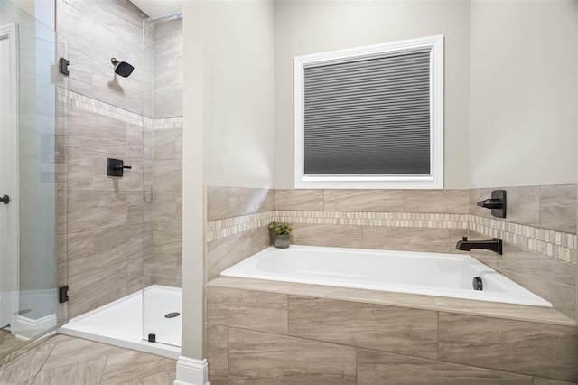 bathroom with a bath and a shower stall