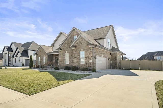 view of front of home with a front lawn, driveway, fence, an attached garage, and brick siding