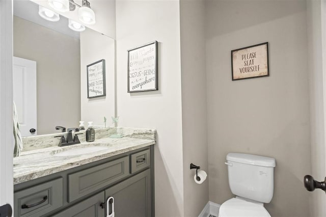 half bathroom featuring toilet and vanity