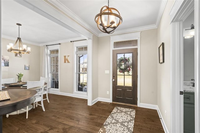 foyer featuring a chandelier, dark wood-type flooring, and ornamental molding