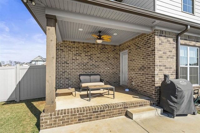 view of patio with grilling area, ceiling fan, and fence