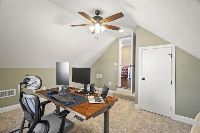 office with visible vents, baseboards, light carpet, and vaulted ceiling