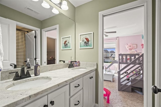 full bath featuring a sink, visible vents, ceiling fan, and double vanity