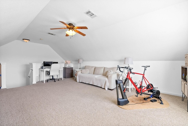 interior space with a ceiling fan, vaulted ceiling, carpet, and visible vents