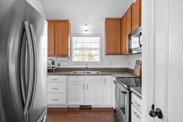 kitchen featuring a sink, dark countertops, brown cabinetry, and stainless steel appliances