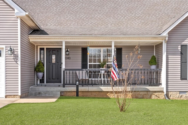 doorway to property featuring a shingled roof, a porch, a lawn, and crawl space