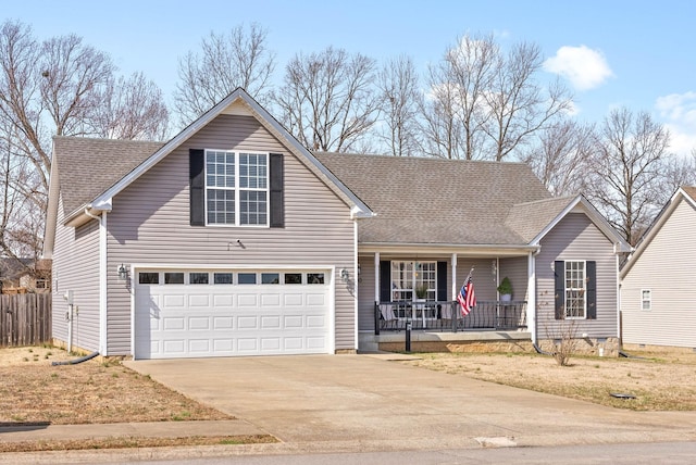 traditional-style house with fence, driveway, roof with shingles, an attached garage, and covered porch