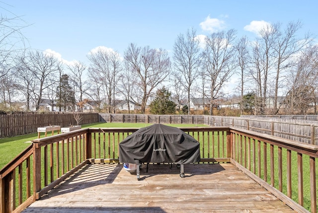 wooden deck with a fenced backyard, area for grilling, and a yard