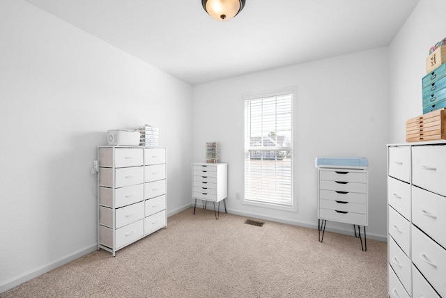 unfurnished bedroom with baseboards, visible vents, and light carpet