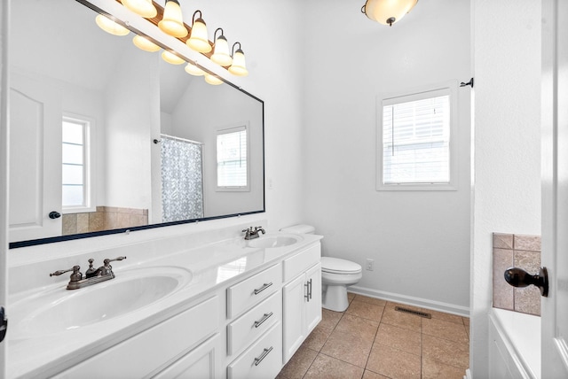 bathroom with double vanity, visible vents, toilet, and a sink