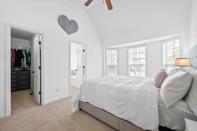 bedroom with a closet, multiple windows, light carpet, and a spacious closet