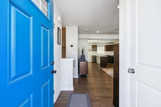 foyer entrance featuring dark wood finished floors, recessed lighting, baseboards, and visible vents