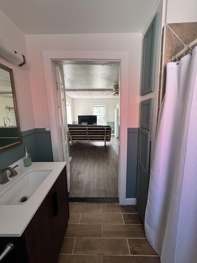 bathroom featuring vanity, ceiling fan, and wood tiled floor