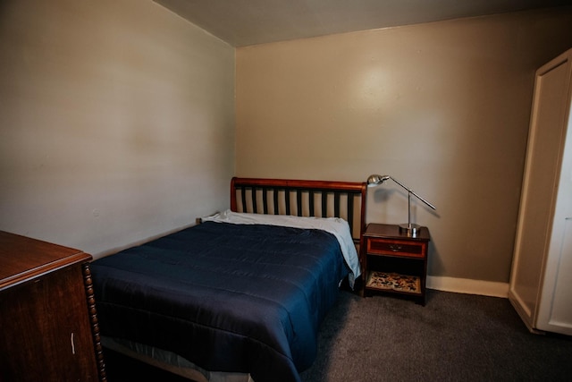 bedroom featuring baseboards and carpet floors