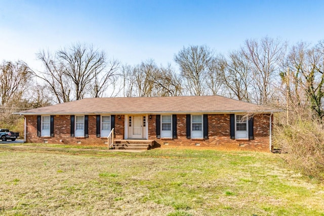 single story home with crawl space, brick siding, roof with shingles, and a front yard