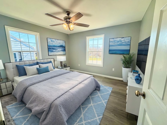 bedroom featuring a ceiling fan, wood finished floors, and baseboards