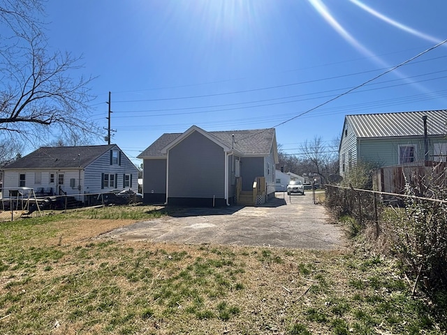 back of house with entry steps and fence