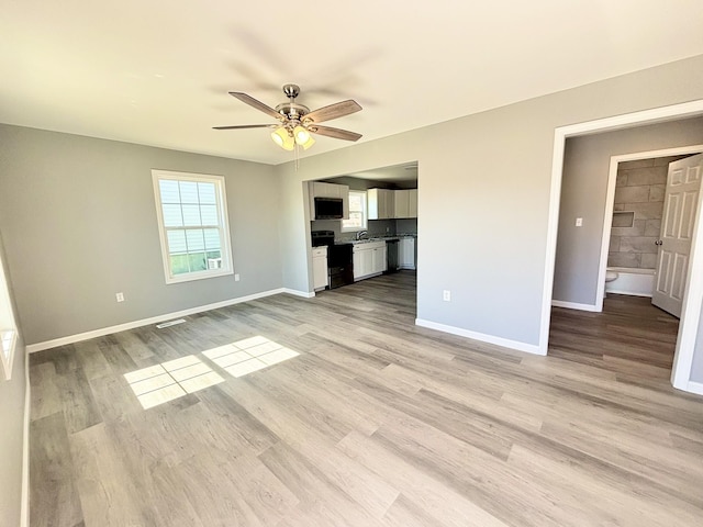 unfurnished living room with visible vents, baseboards, light wood-style floors, and ceiling fan