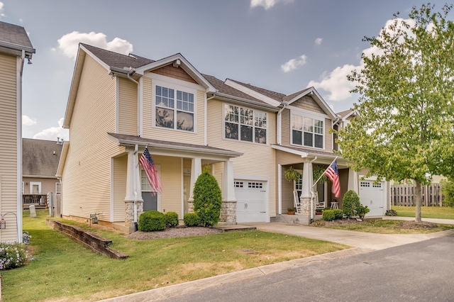 craftsman-style house with a front yard, an attached garage, and driveway