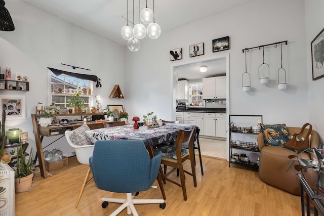 dining space with light wood-type flooring