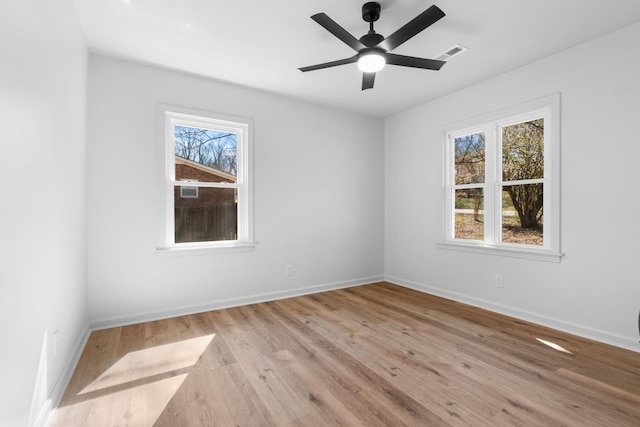 unfurnished room with light wood-type flooring, visible vents, baseboards, and a ceiling fan