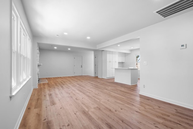 unfurnished living room featuring recessed lighting, visible vents, baseboards, and light wood-style floors