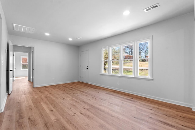 unfurnished room featuring visible vents, recessed lighting, light wood-style floors, and baseboards