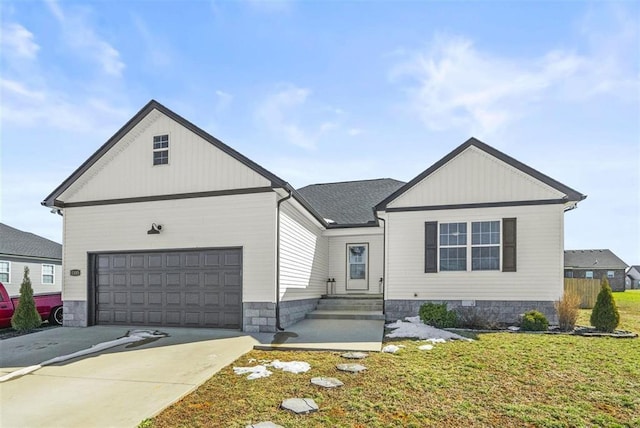 view of front of home with a front lawn, concrete driveway, and a garage