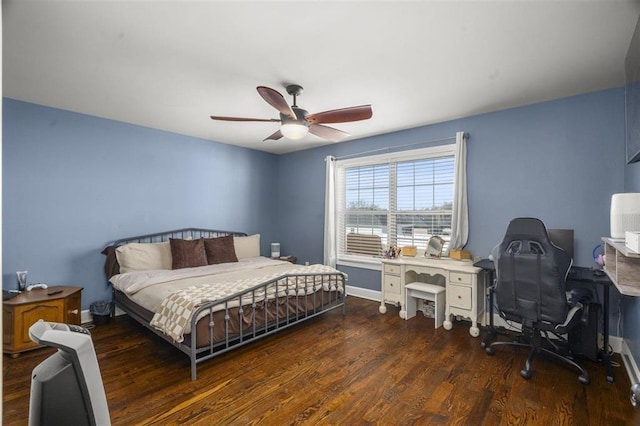 bedroom with a ceiling fan, baseboards, and wood finished floors