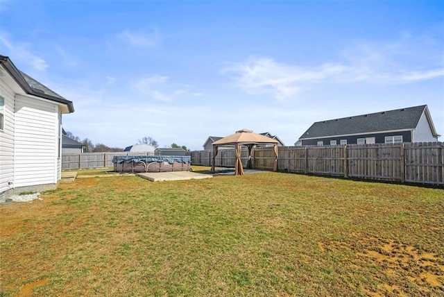 view of yard featuring a gazebo, a patio area, and a fenced backyard