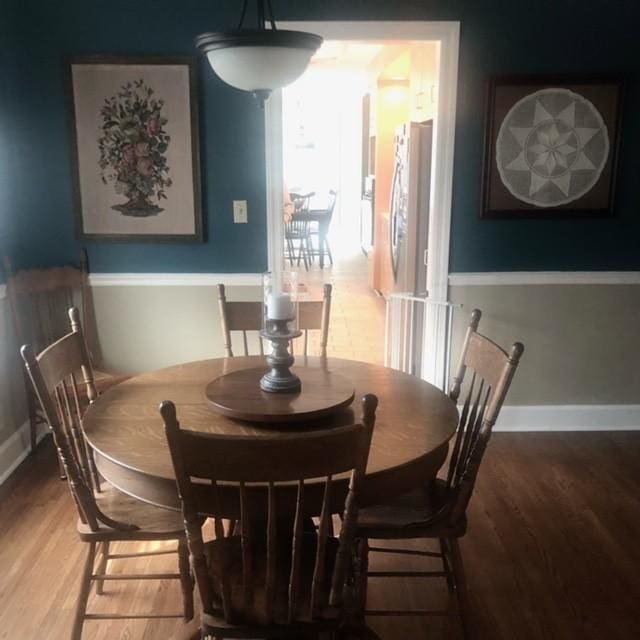 dining room featuring baseboards and wood finished floors