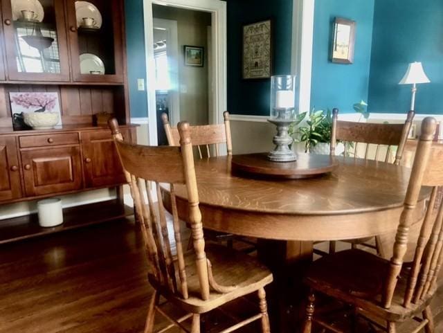 dining space with dark wood-style floors