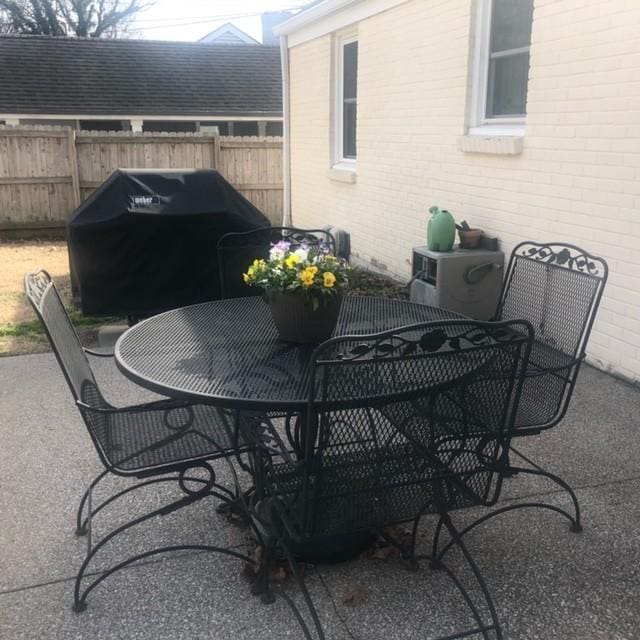 view of patio / terrace with grilling area, outdoor dining area, and fence