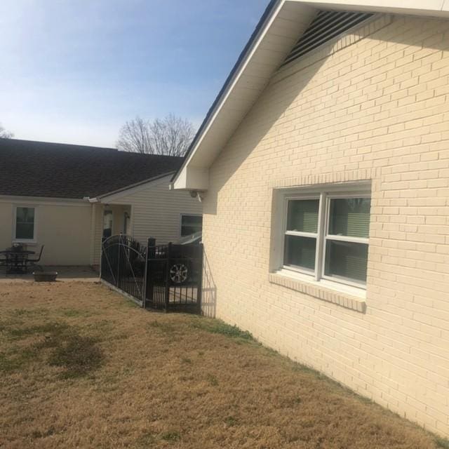 view of side of property featuring a yard and fence