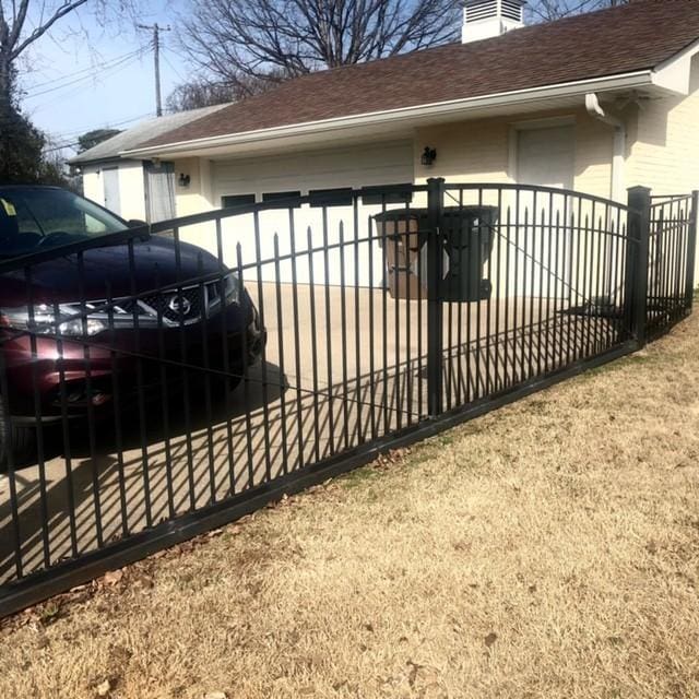 view of gate with fence