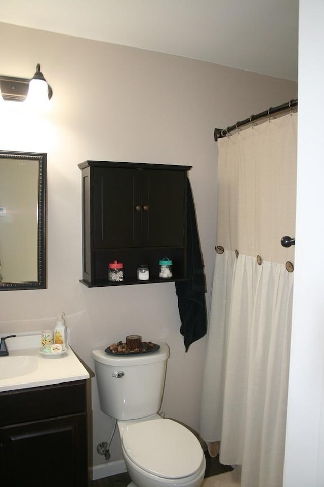 full bath featuring vanity and toilet