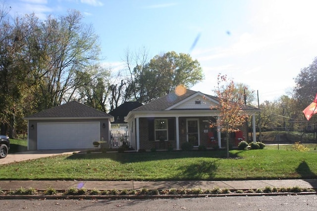 view of front of property with an outbuilding, a garage, a porch, and a front yard