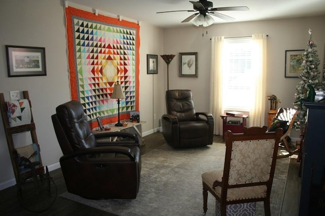 sitting room featuring carpet, a ceiling fan, and baseboards