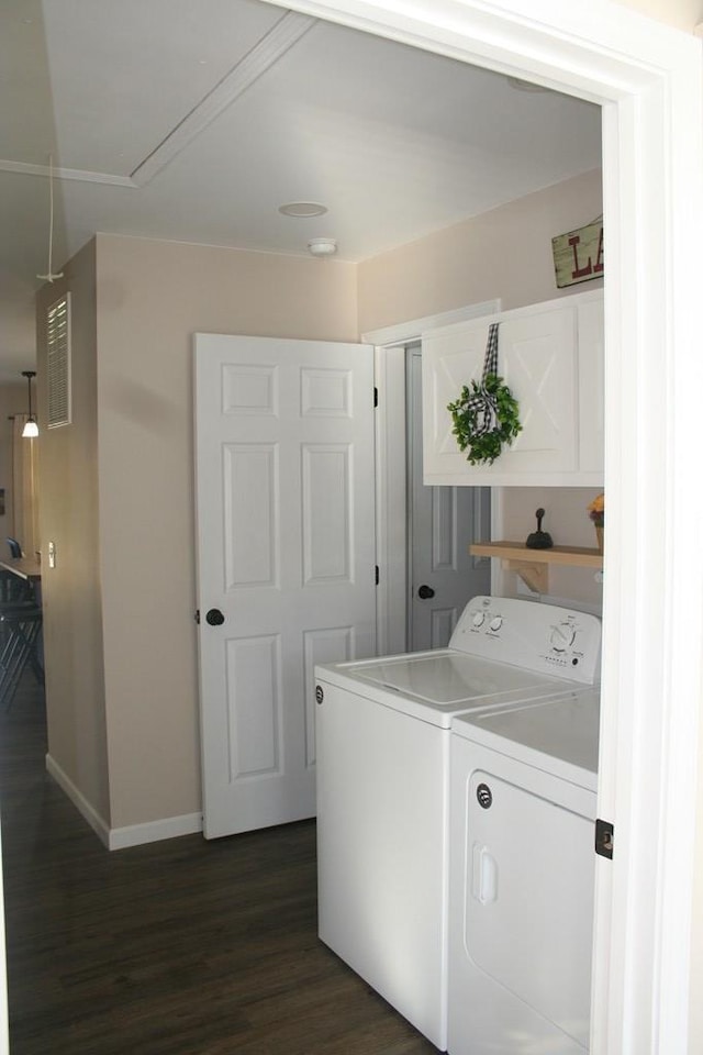 washroom with baseboards, attic access, laundry area, dark wood-style flooring, and washer and dryer