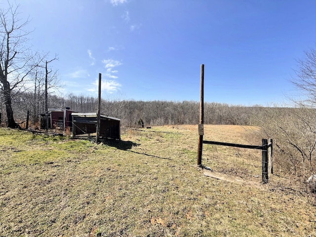 view of yard with a rural view and an outdoor structure