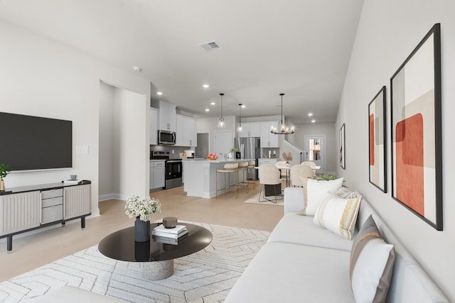 living room with recessed lighting, visible vents, and a chandelier