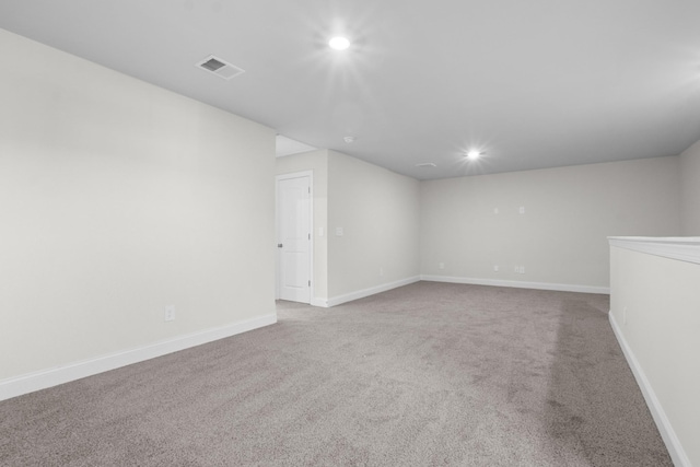 unfurnished room with recessed lighting, visible vents, carpet floors, and baseboards