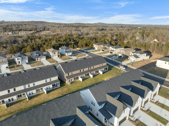 drone / aerial view with a residential view and a forest view