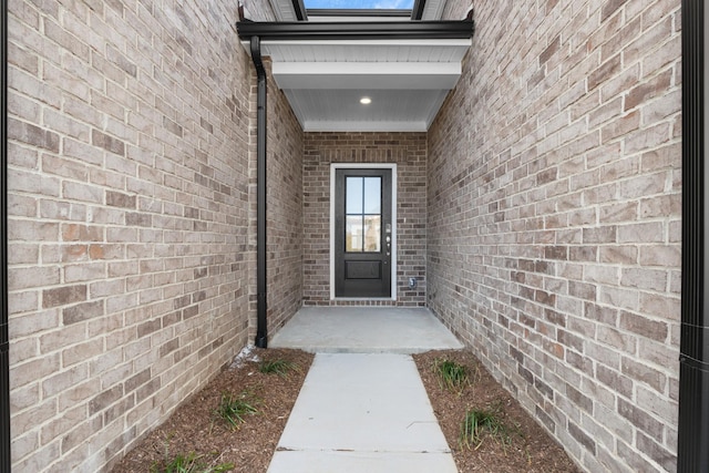 property entrance with brick siding