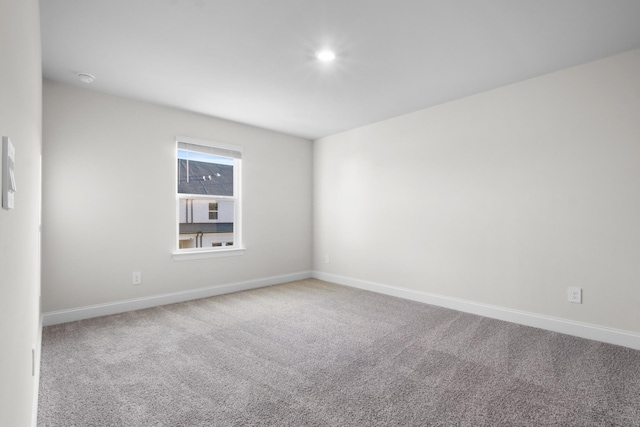 spare room with carpet flooring and baseboards